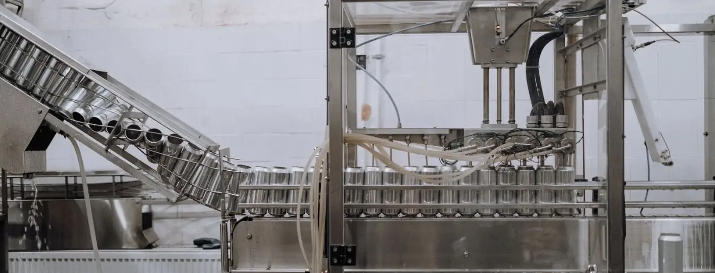 Stainless steel filling and capping machinery in a production hall