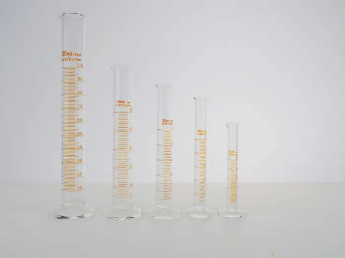 Graduated laboratory glassware holding clear liquids