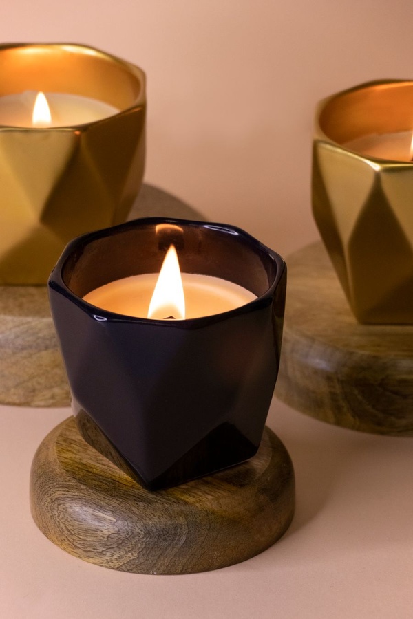 Lit geometric candles in black and gold