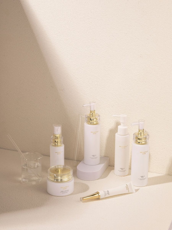 White and gold body care bottles